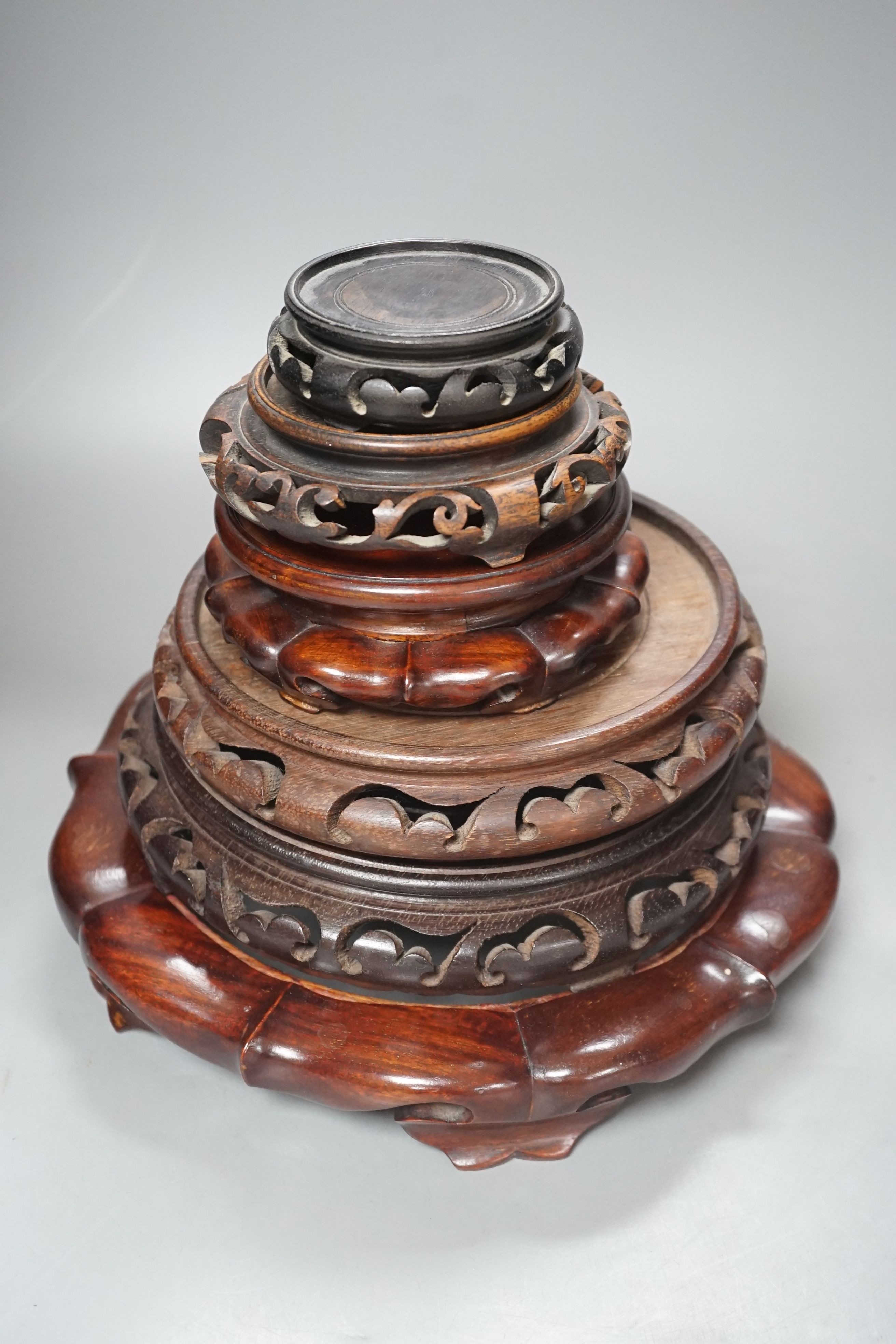 Six Chinese hardwood vase stands- largest 27 diameter.